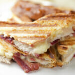 Turkey cranberry bacon panini on a plate.