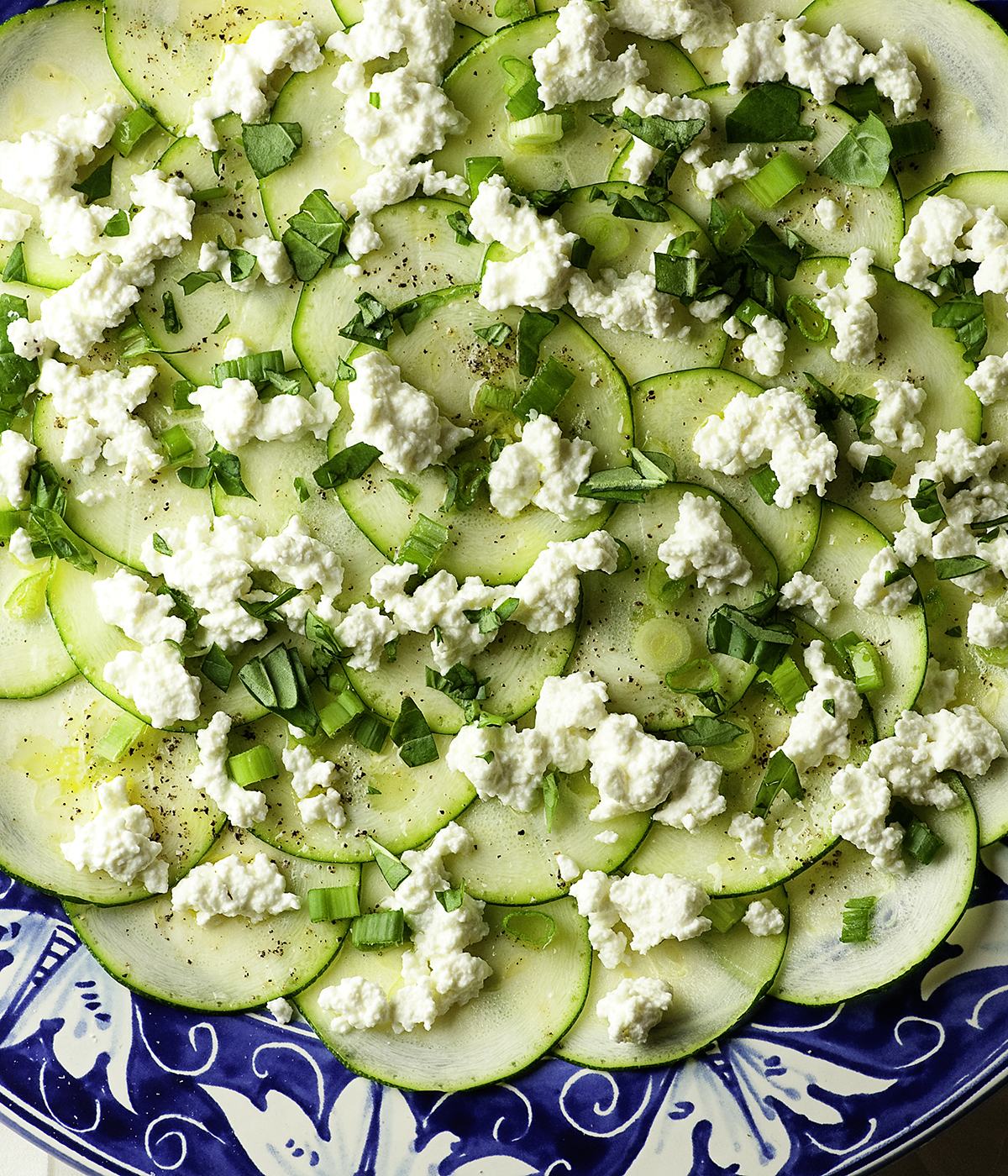 Layered zucchini carpaccio on a plate.