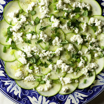 Zucchini carpaccio on a serving dish.