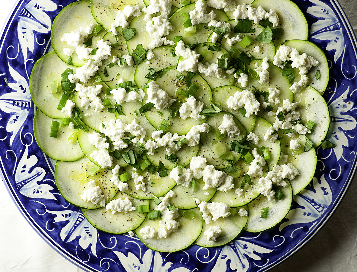 Zucchini carpaccio on a serving dish.