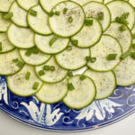 Zucchini carpaccio with scallions.