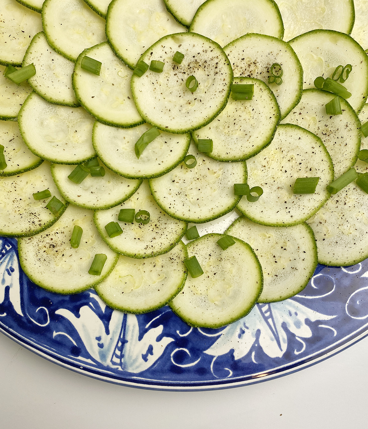 Zucchini carpaccio with scallions.