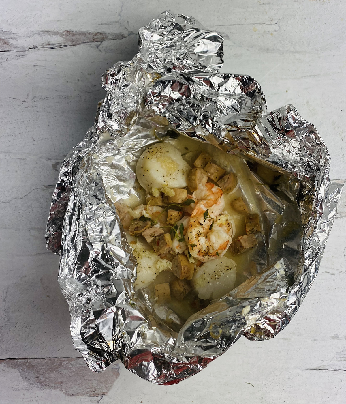 Opened grilled seafood packets