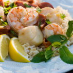 Grilled seafood with lemon on a plate.