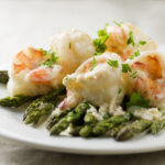 Creamy Chardonnay Shrimp on a plate with asparagus.