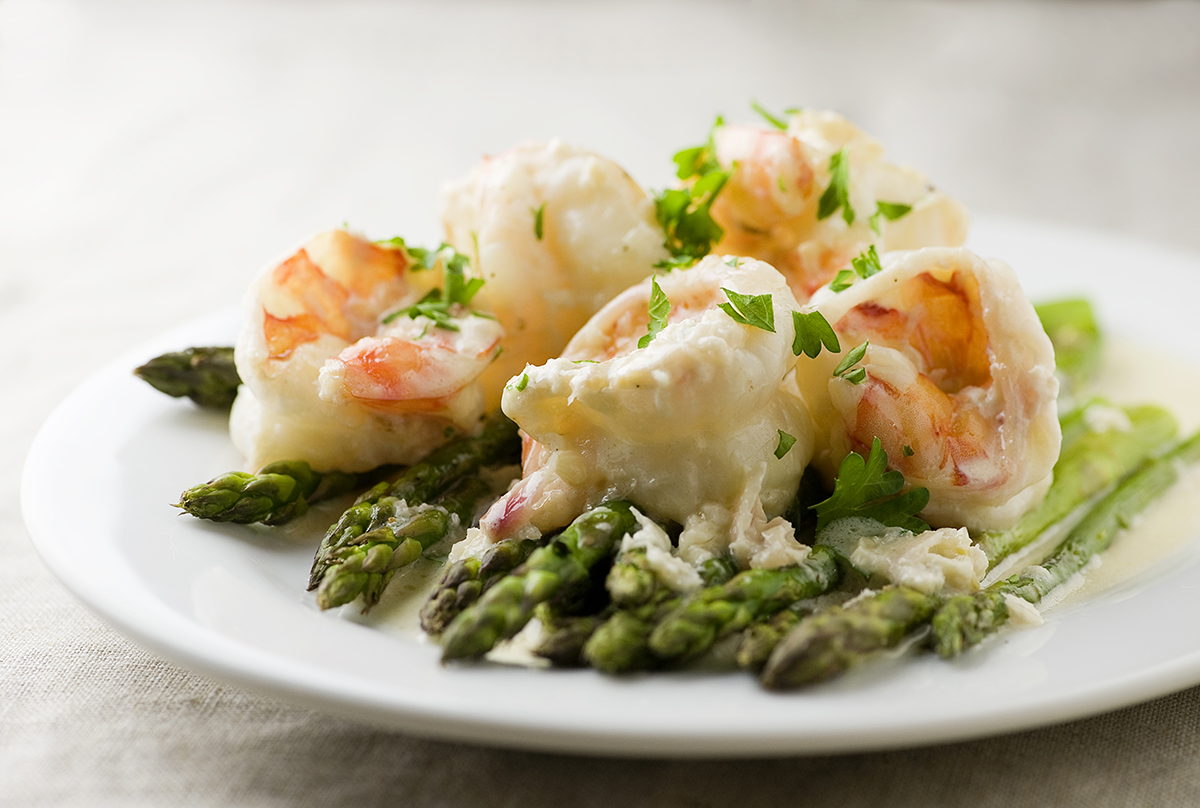 Creamy Chardonnay Shrimp on a plate with asparagus.