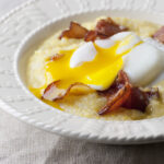 Eggs with bacon grits in a bowl.