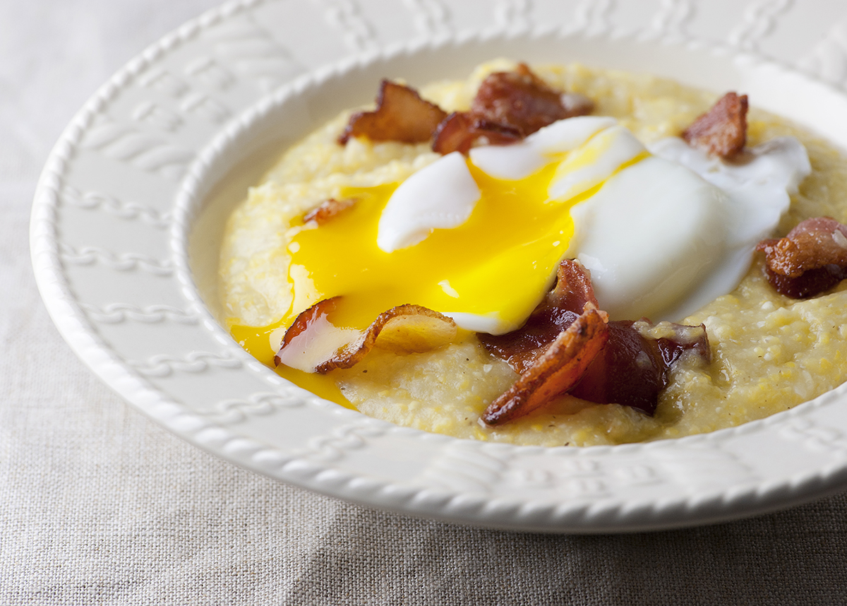 Eggs with bacon grits in a bowl.