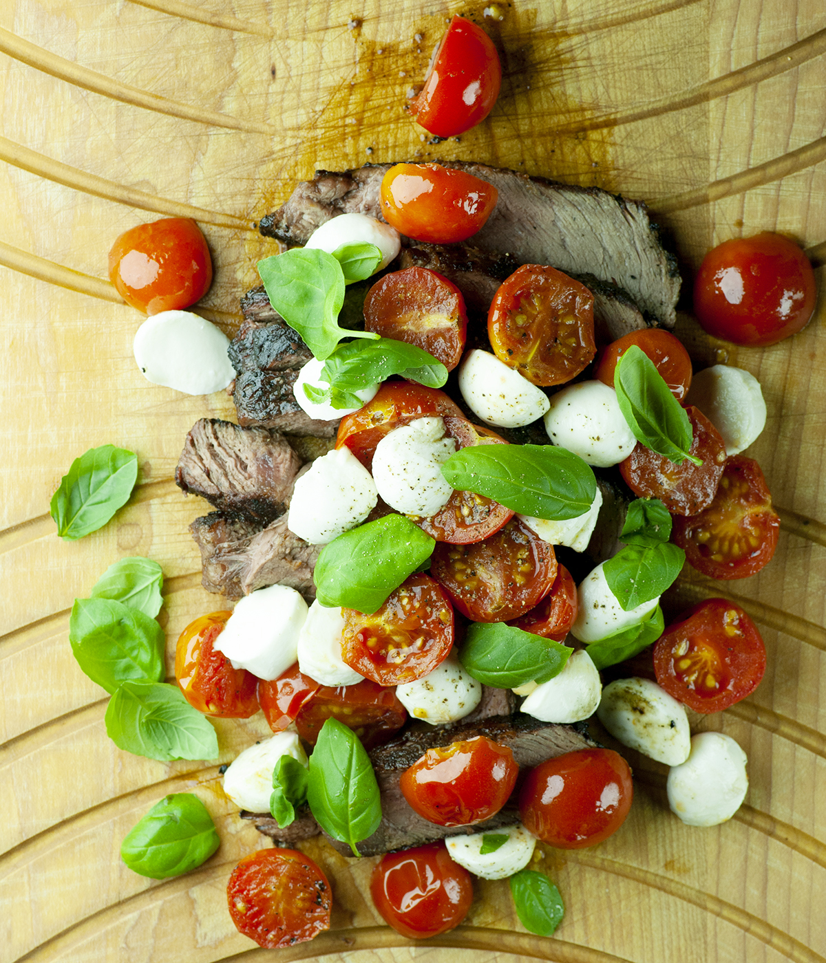 Steak Caprese on a board.