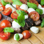 Steak Caprese on a cutting board.