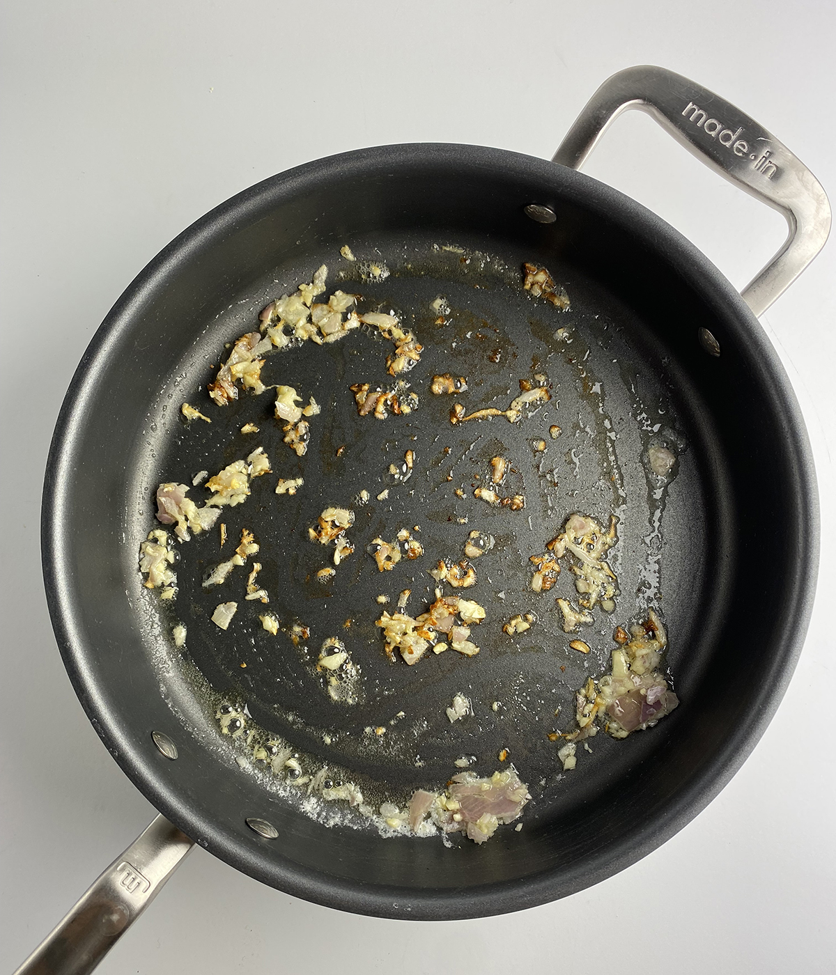 Shallots cooking in a skillet.