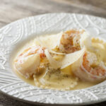 Shrimp scampi ravioli on a plate.