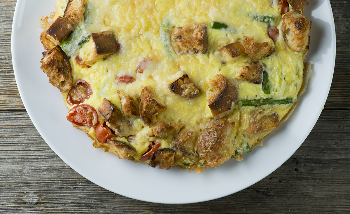 Baked Vegetable Frittata on a wooden counter.