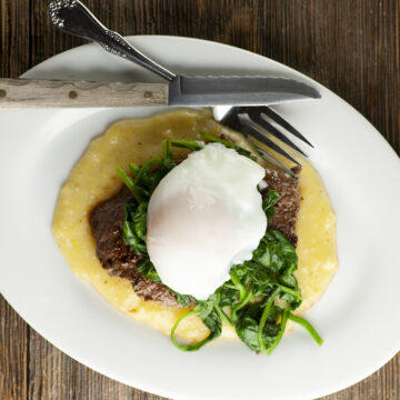 Steak eggs and spinach on a plate.