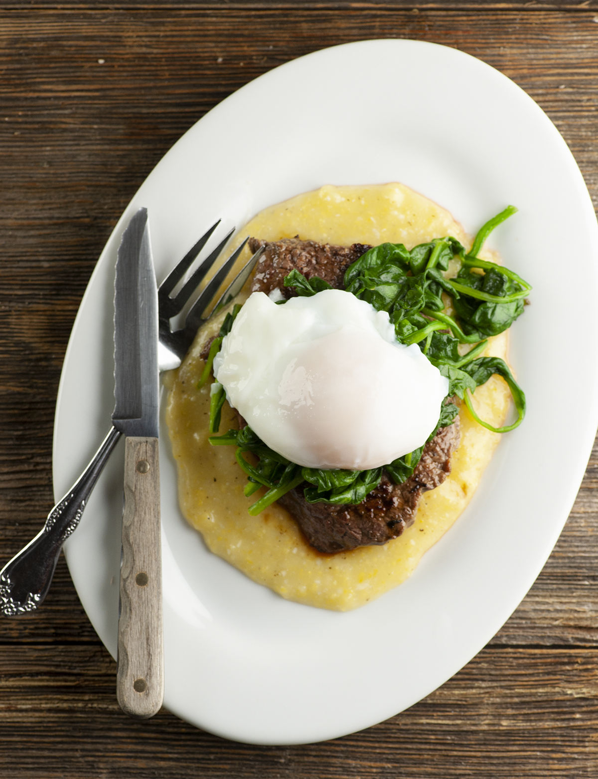 Steak and Eggs with spinach on a plate.