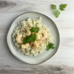 Shrimp with blue cheese sauce on a plate.