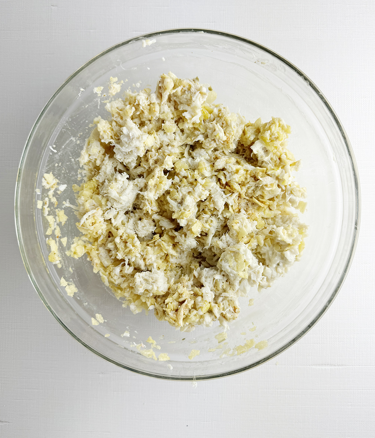 Crab cake mixture in a mixing bowl.