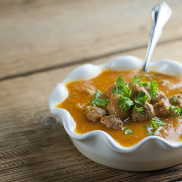 Tomato meatball soup in a bowl.