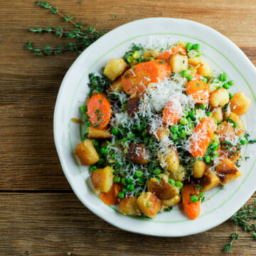 Plate of gnocchi with spring vegetables.