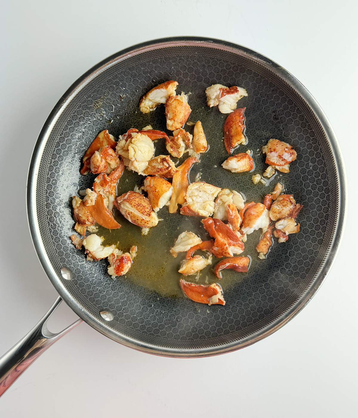 Cooked lobster in a skillet.