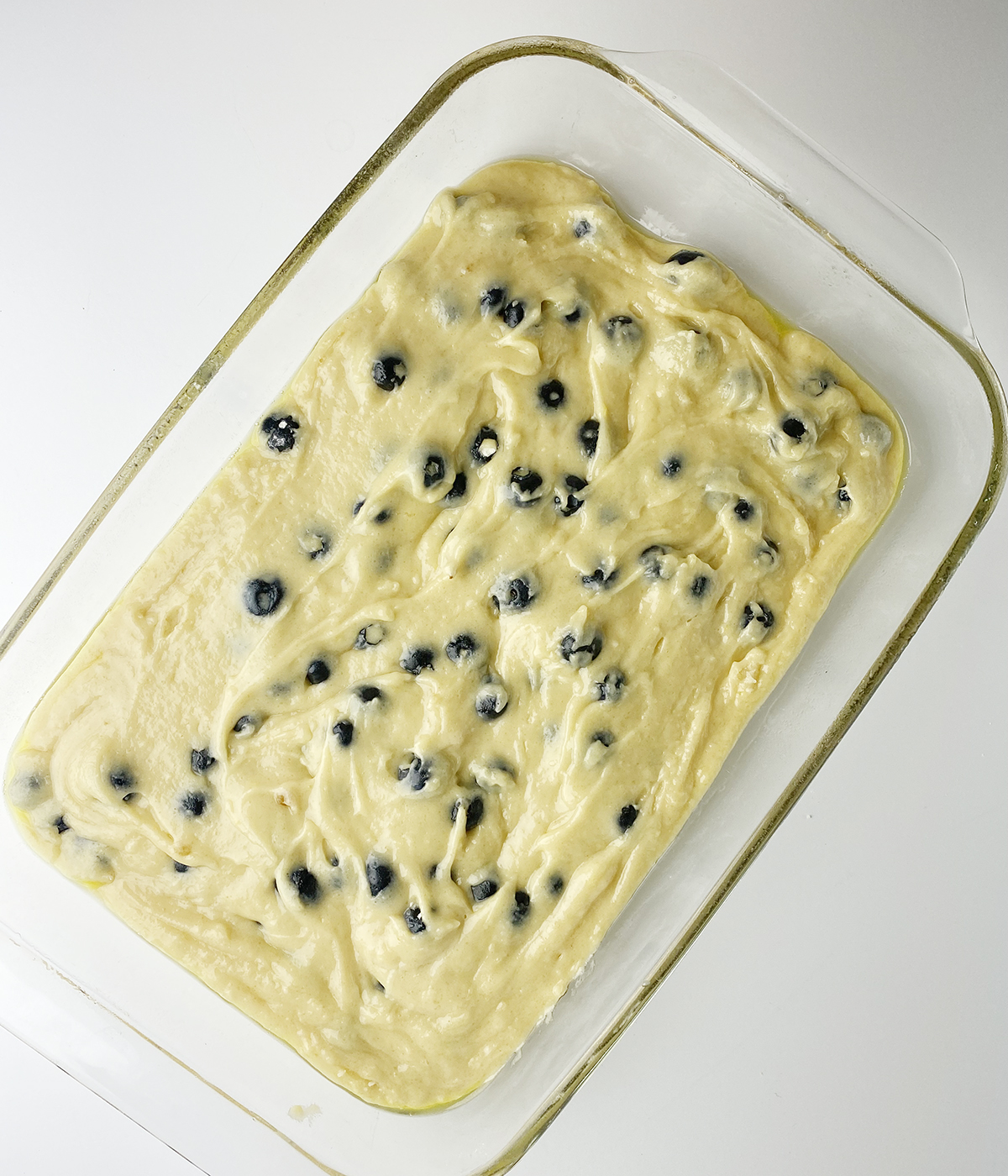 Blueberry boy bait batter in a baking pan.