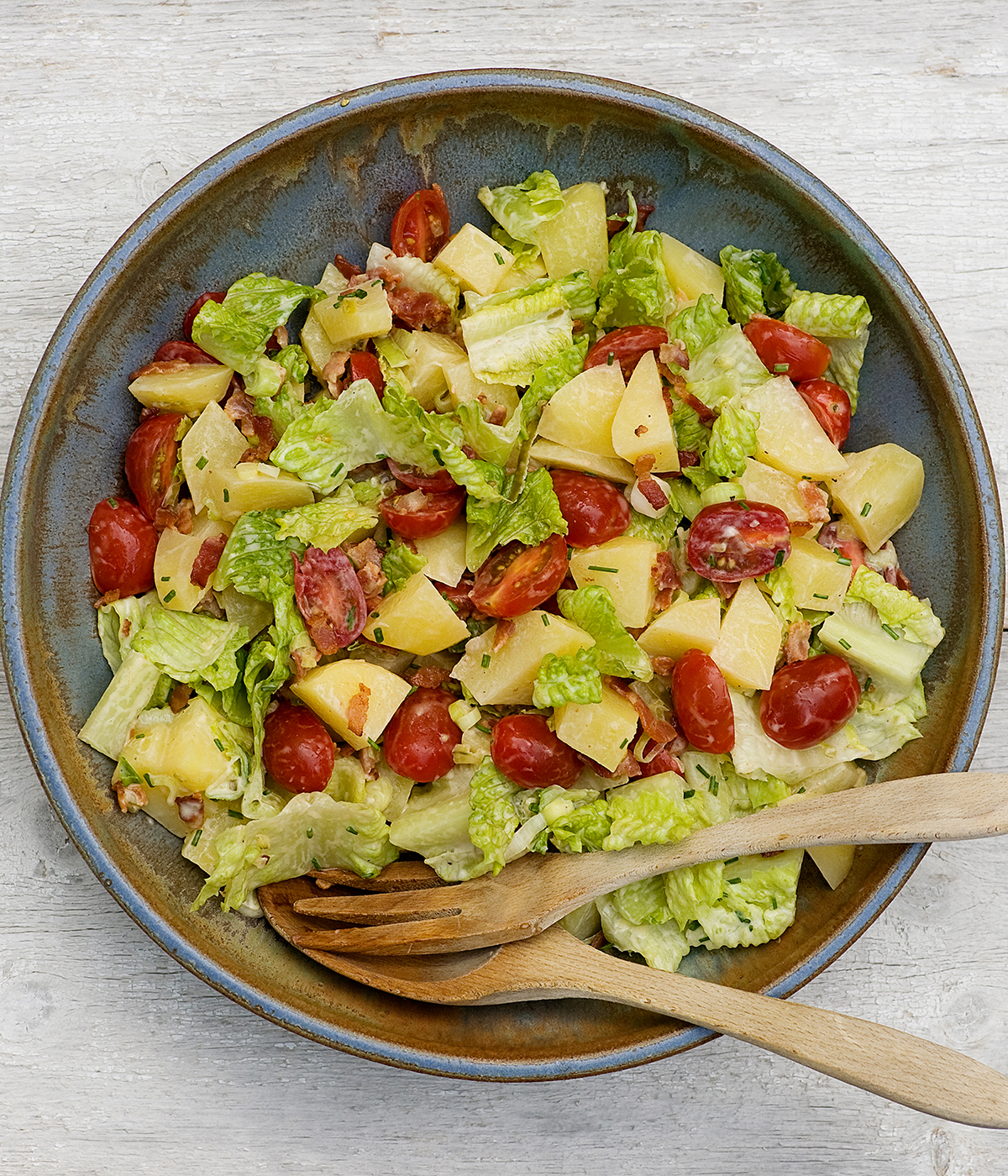 Bacon lettuce and tomato potato salad in bowl.